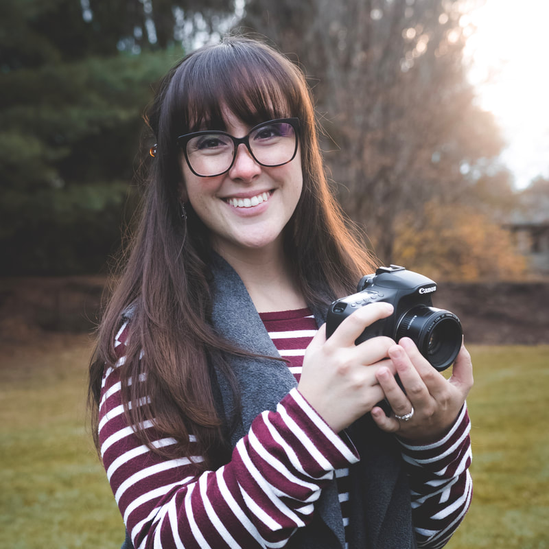 Photo of Rachel holding a camera